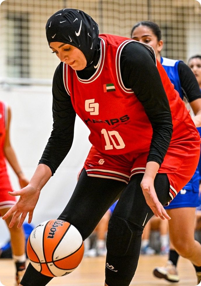 A Women Open Cup player driving to the basket